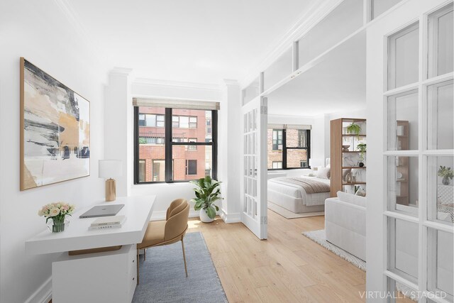 office featuring baseboards, french doors, light wood finished floors, and crown molding