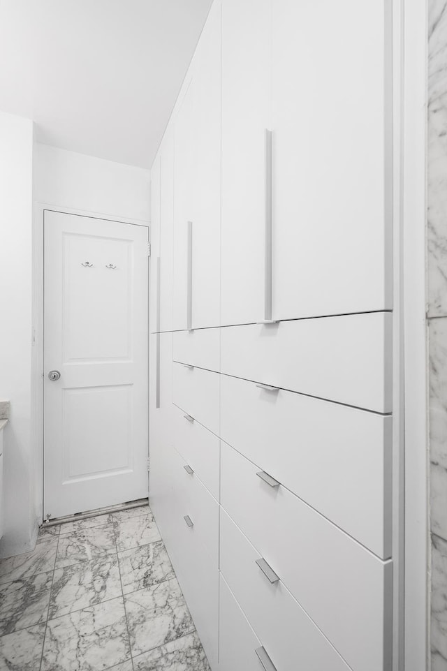 spacious closet with marble finish floor