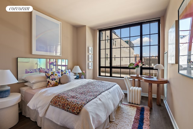 bedroom featuring dark wood-type flooring, visible vents, and baseboards