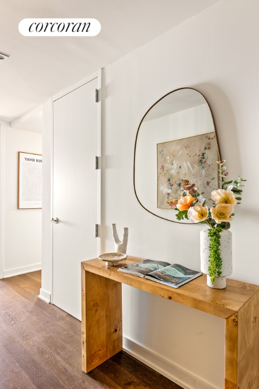 hall featuring wood finished floors and baseboards