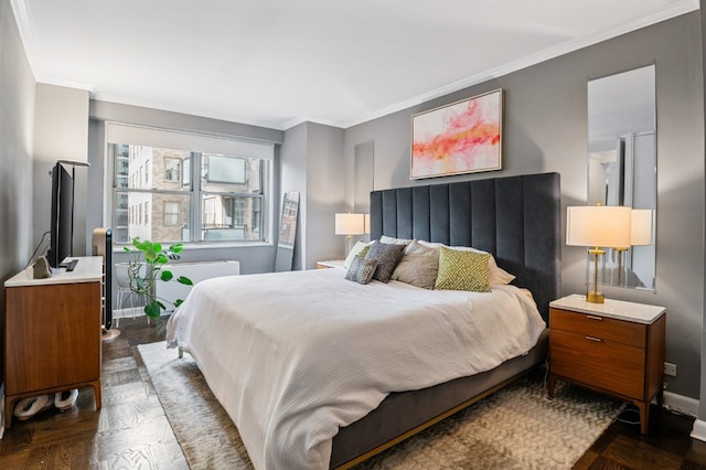 bedroom with radiator heating unit, crown molding, and dark parquet floors