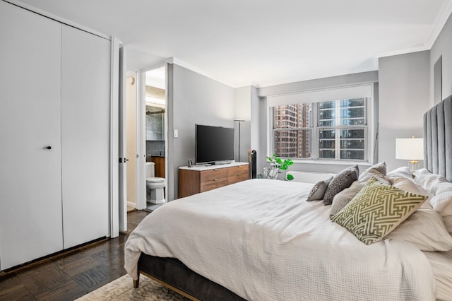 bedroom featuring ensuite bathroom, a closet, and dark parquet floors