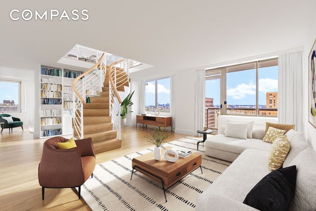 living room featuring stairs, plenty of natural light, and wood finished floors