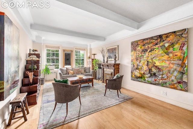 living room with beam ceiling and light hardwood / wood-style floors