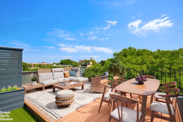 wooden terrace with outdoor dining area and outdoor lounge area