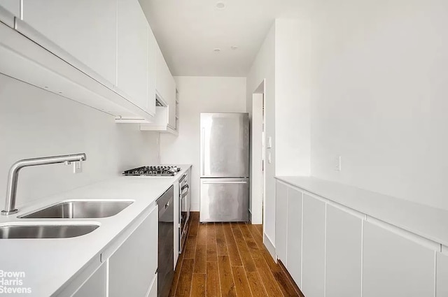 406 Greene Ave Unit 3, New York City, NY 11216 - kitchen with stainless steel appliances, light countertops, white cabinetry, dark wood-type flooring, and modern cabinets