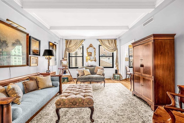 living room featuring beam ceiling, ornamental molding, and light wood-type flooring