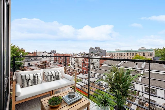 balcony featuring a view of city and outdoor lounge area