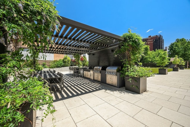 view of patio / terrace with a pergola, a grill, and an outdoor kitchen