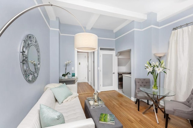 living room with beamed ceiling and hardwood / wood-style floors