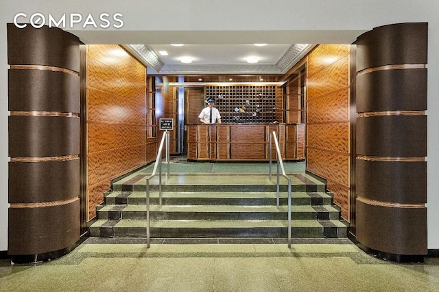 stairs featuring wooden walls