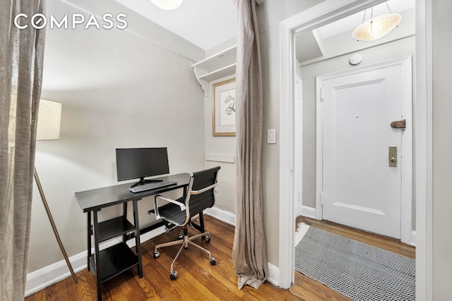 home office with wood finished floors and baseboards