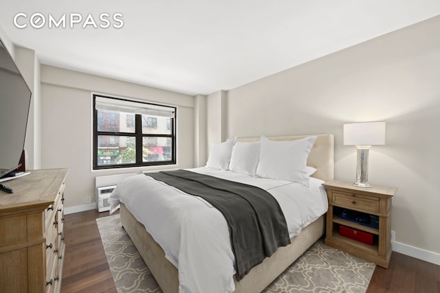 bedroom featuring baseboards and dark wood finished floors