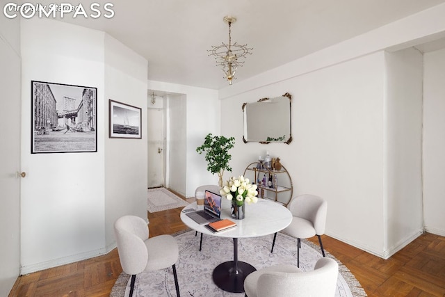 dining area featuring parquet flooring