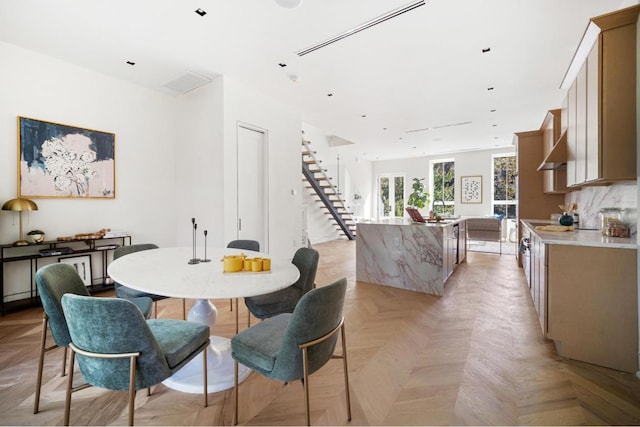 dining area featuring light parquet flooring and sink