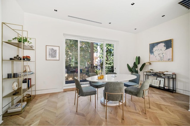 dining space with light parquet flooring