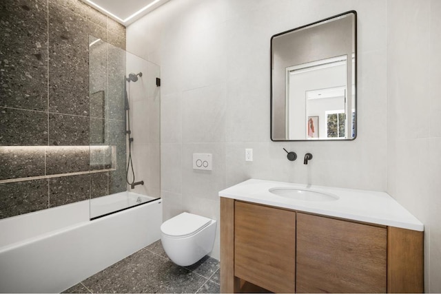 full bathroom with toilet, vanity, shower / bath combination with glass door, and tile walls