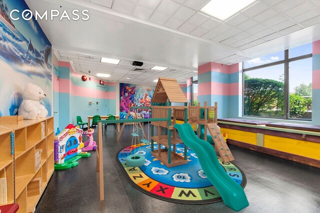 recreation room featuring a drop ceiling