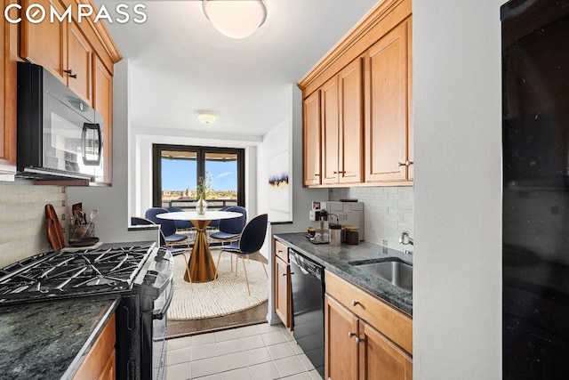 kitchen with sink, black appliances, light tile patterned flooring, decorative backsplash, and dark stone counters