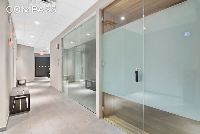 interior space featuring a drop ceiling and tile patterned flooring