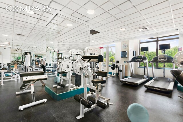 workout area with visible vents and a drop ceiling