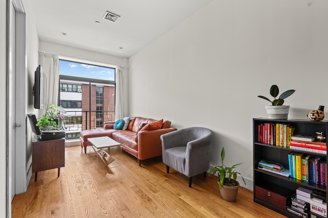 living room featuring visible vents and light wood-type flooring