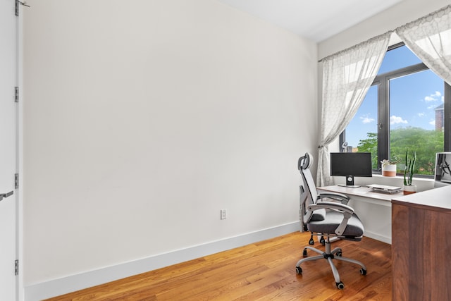 office with wood finished floors and baseboards