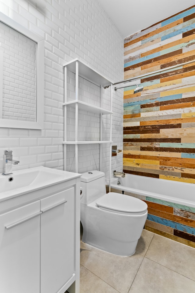 bathroom with wooden walls, toilet, bathtub / shower combination, tile patterned floors, and vanity