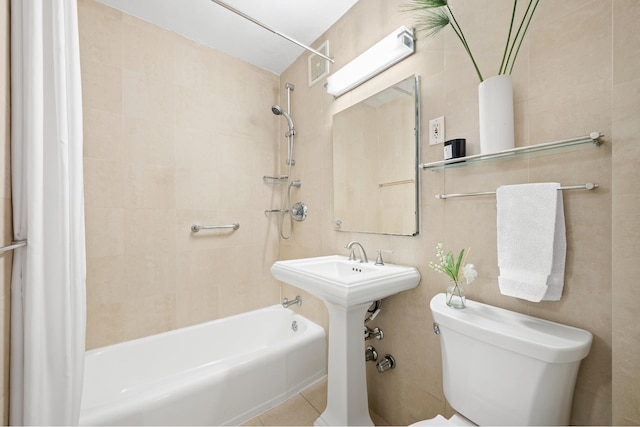 bathroom featuring visible vents, toilet, and shower / bathtub combination with curtain