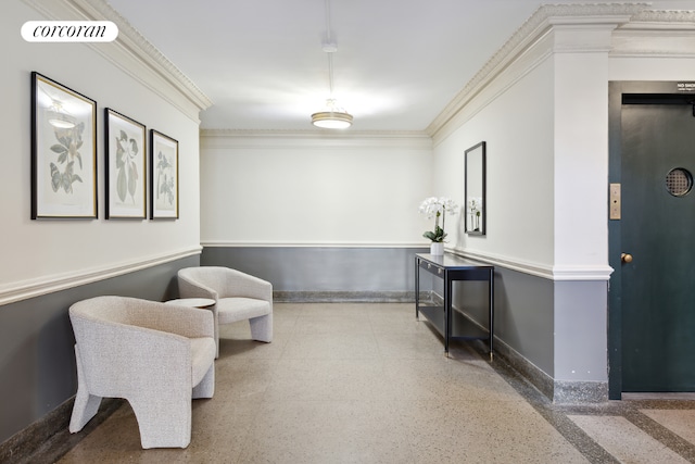 sitting room featuring elevator and ornamental molding