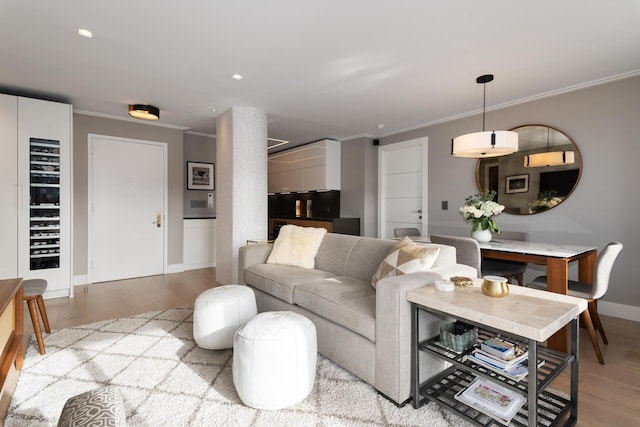 324 W 23rd St Unit 5B, New York City, NY 10011 - living room with crown molding, light wood-style floors, baseboards, and recessed lighting