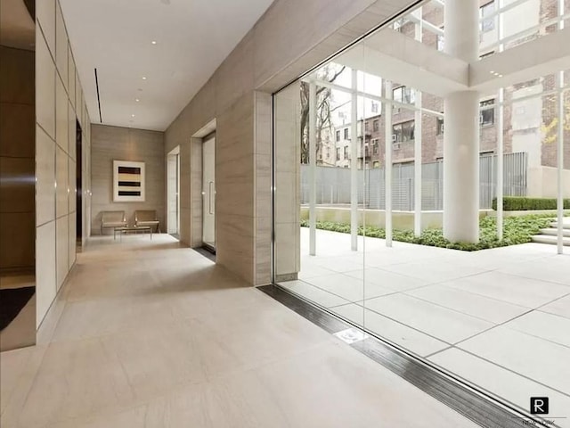 hallway with a towering ceiling and a wealth of natural light