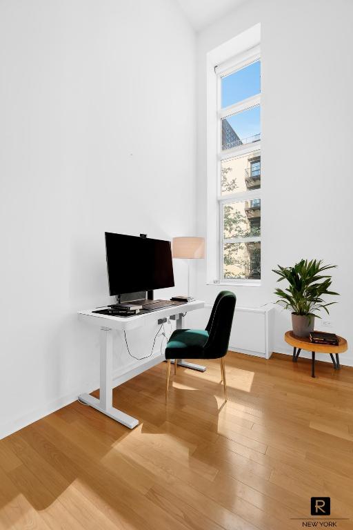 home office with light wood-style floors