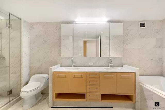 310 E 53rd St Unit 2/3C, New York City, NY 10022 - bathroom featuring tile walls, a marble finish shower, double vanity, a bath, and toilet