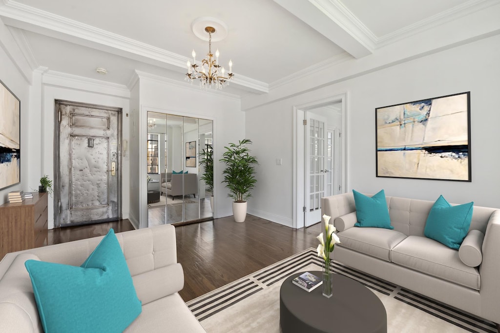 living room with baseboards, ornamental molding, wood finished floors, an inviting chandelier, and beam ceiling