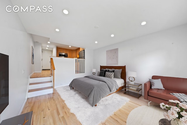 bedroom with recessed lighting, baseboards, light wood-style floors, and freestanding refrigerator