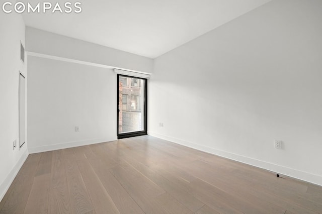 empty room with light hardwood / wood-style floors