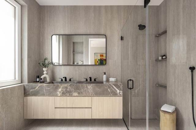 bathroom featuring vanity and an enclosed shower