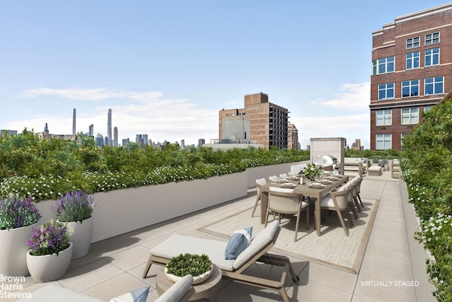 view of patio featuring outdoor dining area and a city view