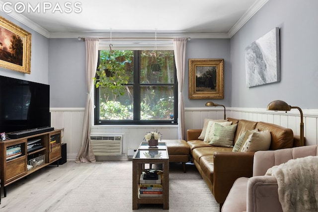 living room featuring ornamental molding, plenty of natural light, a wall mounted air conditioner, and light wood-type flooring