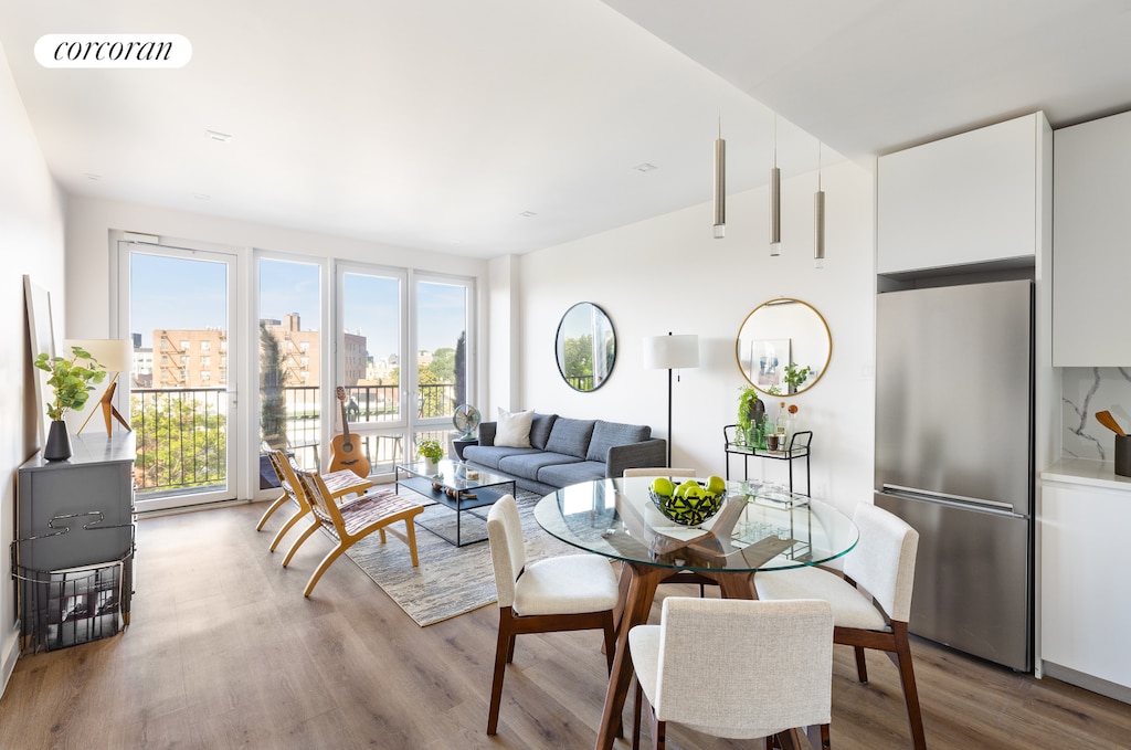 dining space featuring a view of city, wood finished floors, and visible vents