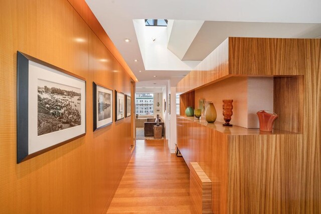 hallway featuring crown molding and an inviting chandelier