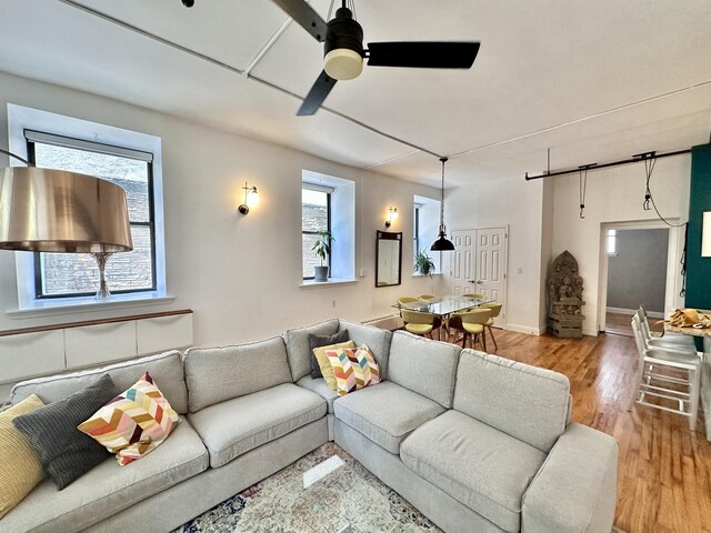 living room featuring ceiling fan and light wood-type flooring