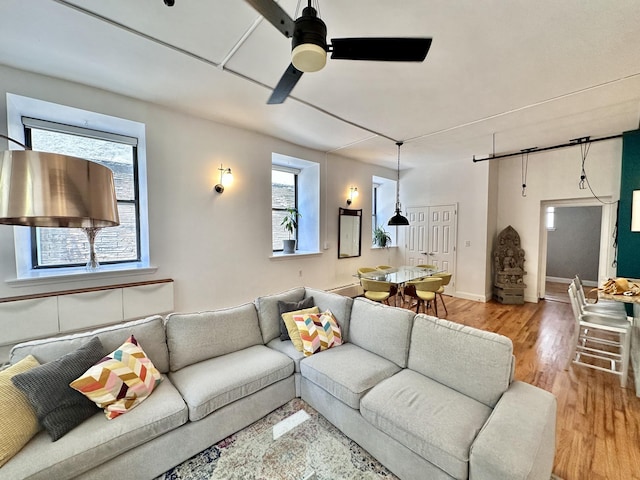 living room featuring ceiling fan and light wood finished floors