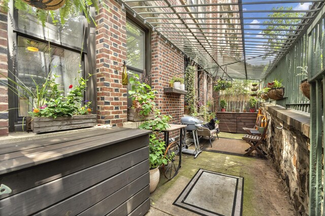 view of patio with fence, grilling area, and a pergola