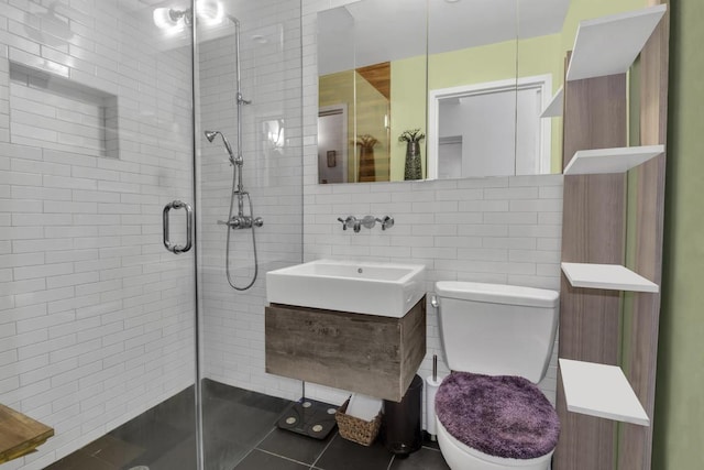 bathroom featuring a shower with shower door, tile walls, toilet, and tile patterned flooring