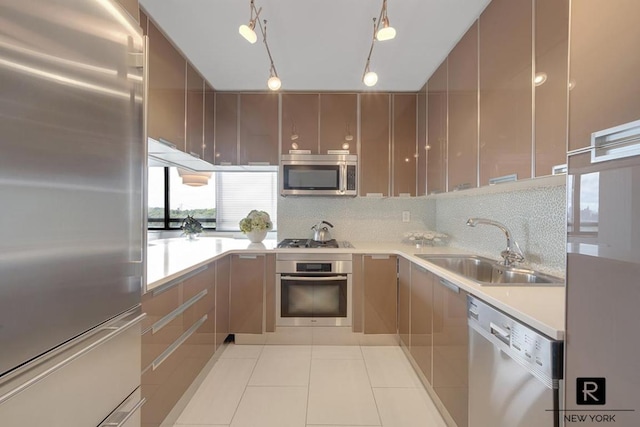 kitchen featuring modern cabinets, appliances with stainless steel finishes, light countertops, a sink, and light tile patterned flooring