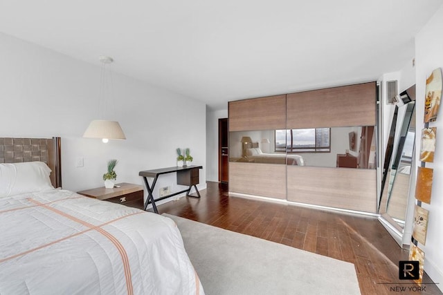 bedroom with dark wood-style floors