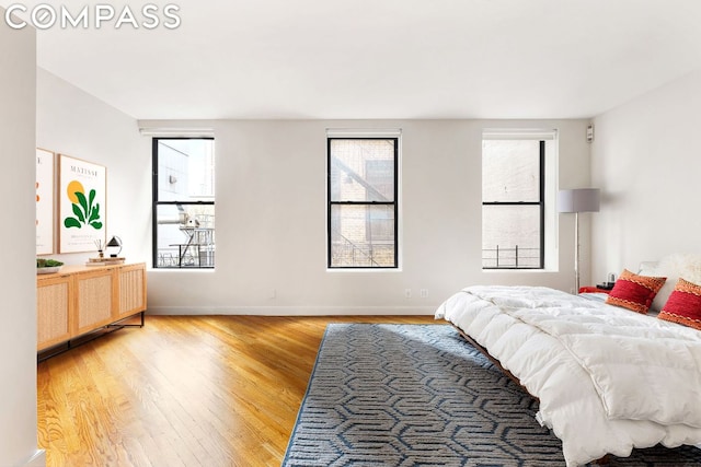 bedroom featuring wood-type flooring and multiple windows