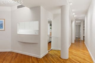 hallway with hardwood / wood-style flooring